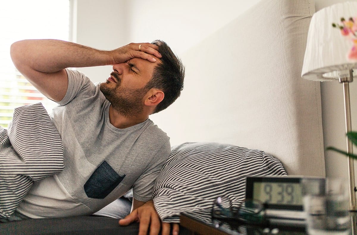 Can TMD contribute to migraines-min man with morning headache, a symptom of sleep apnea